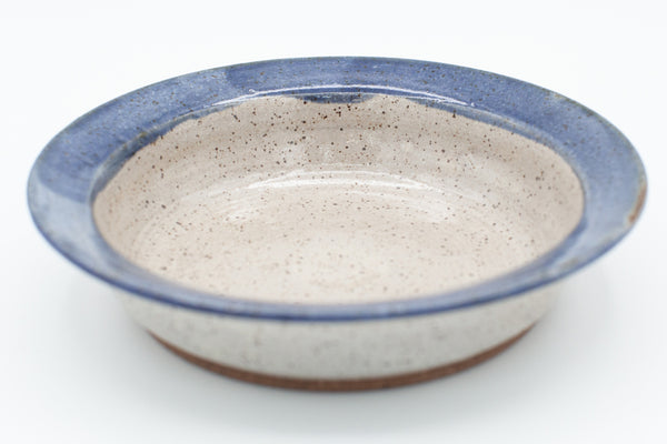 Pasta bowl in speckled clay with Spiced Cream and Blue glaze
