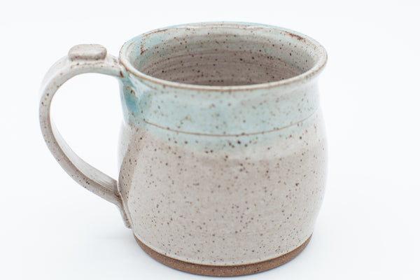 Mug in speckled clay with spiced cream and teal glaze
