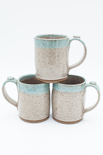 Mug in speckled clay with Spiced Cream and Teal glaze