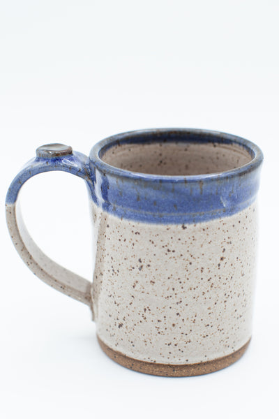 Mug in speckled clay with Spiced Cream and Blue glaze
