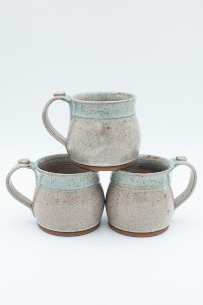 Mug in speckled clay with spiced cream and teal glaze
