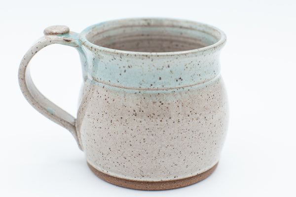Mug in speckled clay with spiced cream and teal glaze