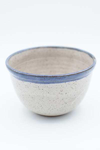Everyday bowl in speckled clay with spiced cream and blue glaze