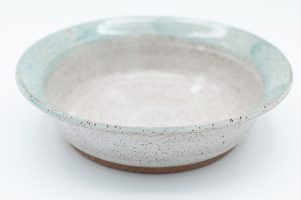 Bowl in speckled clay with spiced cream and teal glaze
