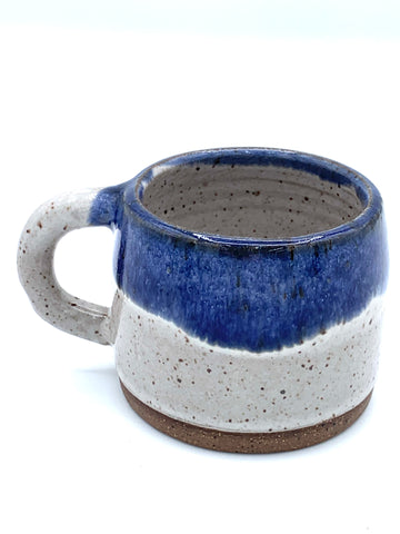 Espresso cup in speckled clay with Spiced cream and Blue glaze