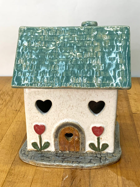 Clay cottage with a Teal roof