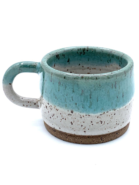 Espresso cup in speckled clay with Spiced cream and Teal glaze