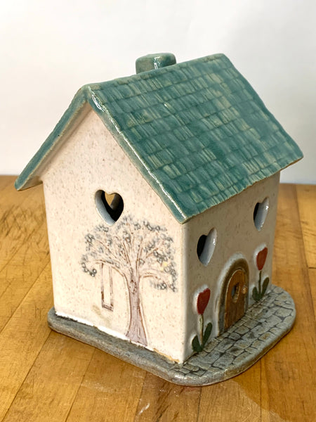 Clay cottage with a Teal roof