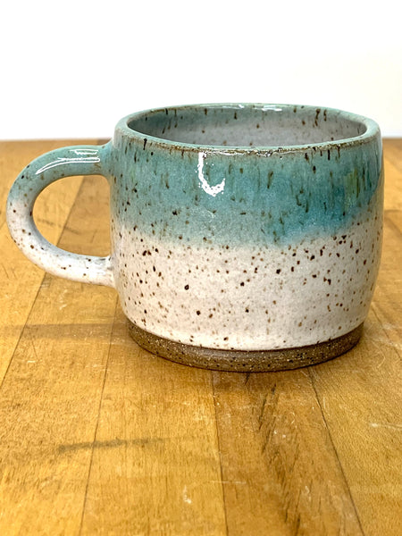 Espresso cup in speckled clay with Spiced cream and Teal glaze