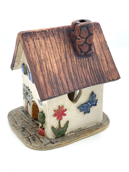 Clay Cottage with cream walls and blue shutters