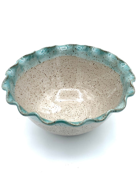 Bowl with scalloped rim in speckled clay with Spiced cream and Teal glaze