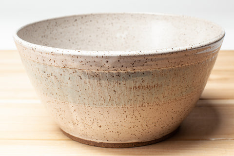 Bowl in speckled clay with Spiced Cream and Teal glaze