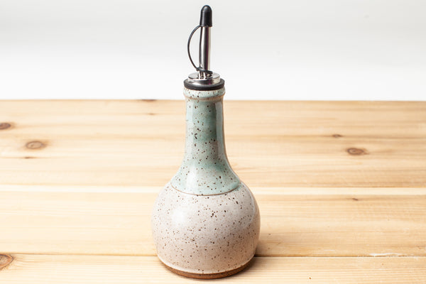 Oil Bottle in speckled clay with Spiced Cream and Teal glaze