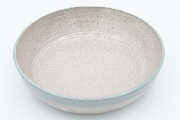 Bowl in speckled clay with Spiced Cream and Teal glaze