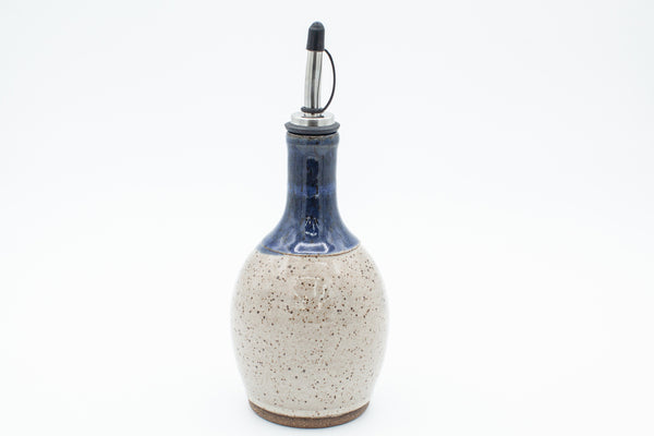 Oil bottle in speckled clay with Spiced Cream and Blue glaze