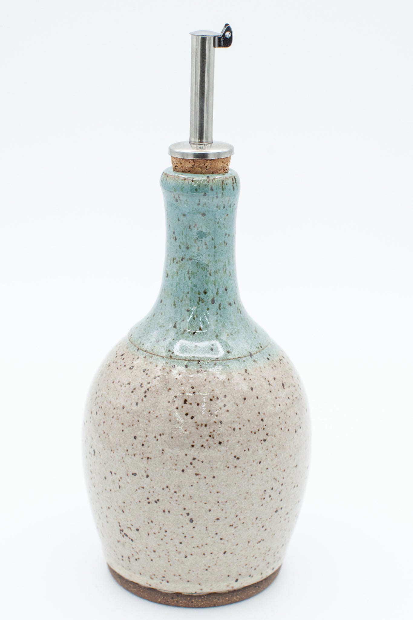 Oil bottle in speckled clay with Spiced Cream and Teal glaze