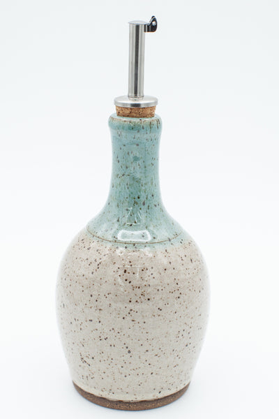 Oil bottle in speckled clay with Spiced Cream and Teal glaze