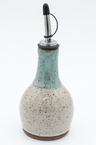 Oil bottle in speckled clay with Spiced Cream and Teal glaze