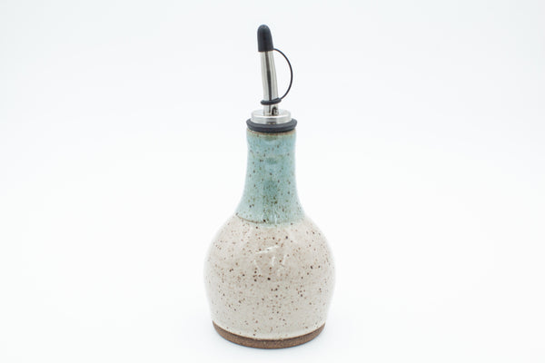 Oil bottle in speckled clay with Spiced Cream and Teal glaze