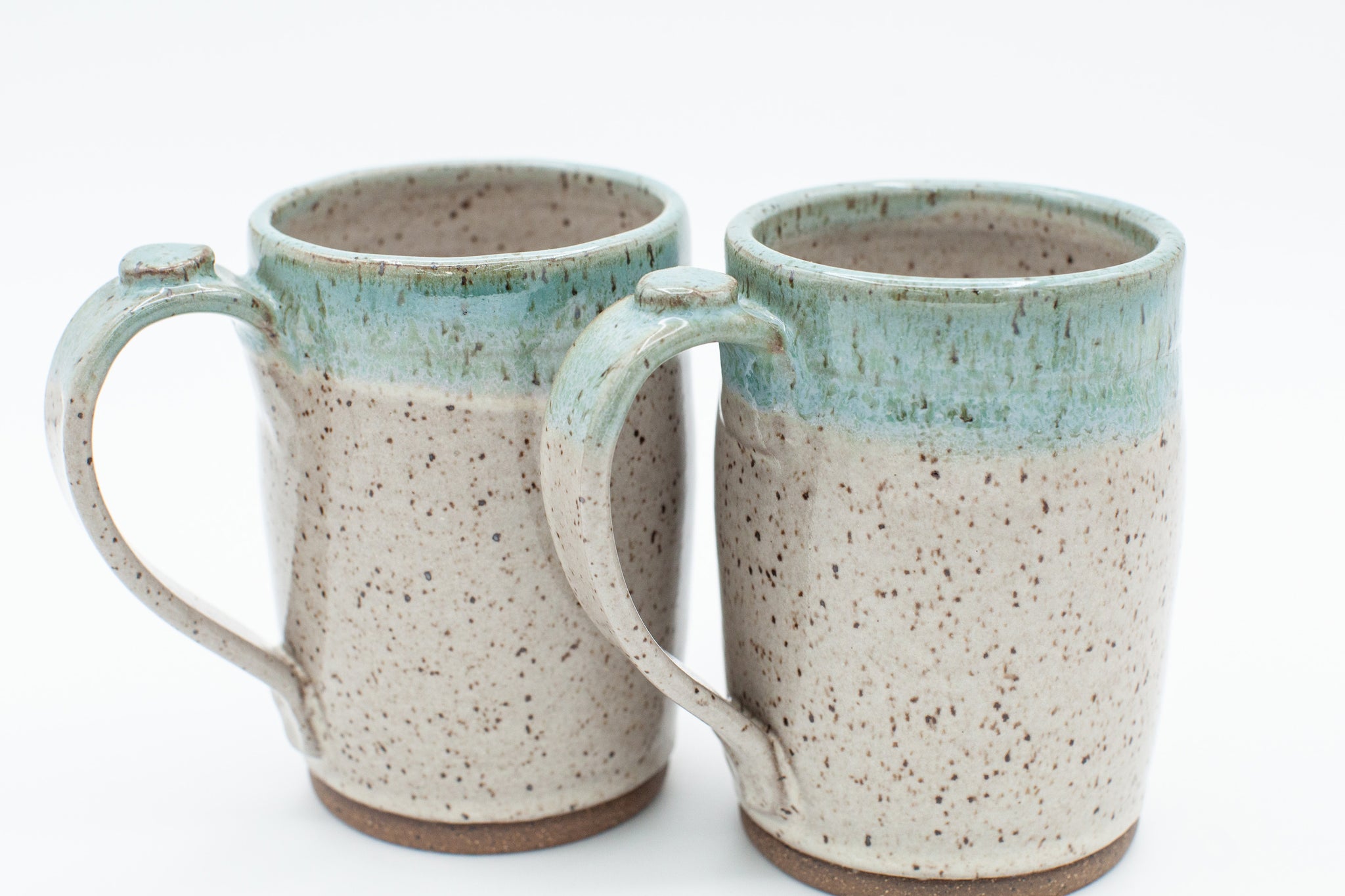 Mug in speckled clay with Spiced Cream and Teal glaze