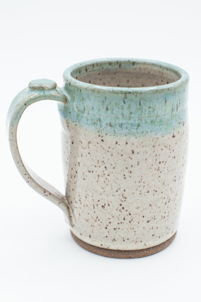 Mug in speckled clay with Spiced Cream and Teal glaze