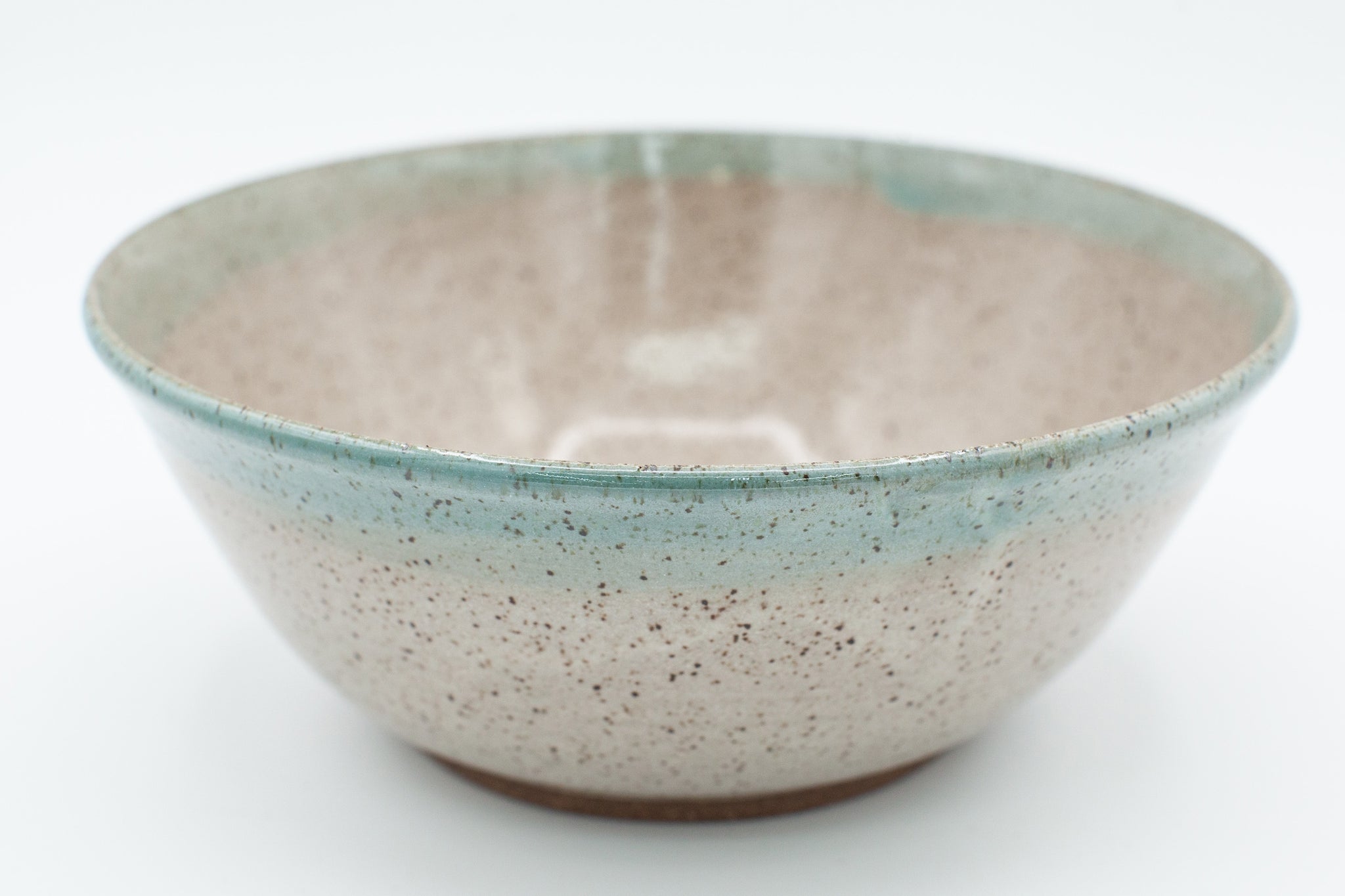 Bowl in speckled clay with Spiced Cream and Teal glaze