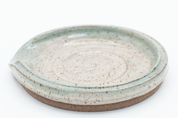 Spoon rest in speckled clay with Spiced Cream and Teal glaze