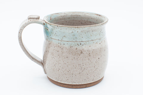 Mug in speckled clay with spiced cream and teal glaze