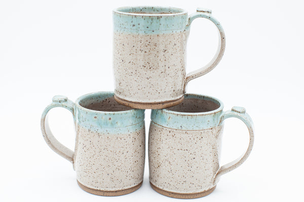 Mug in speckled clay with Spiced Cream and Teal glaze