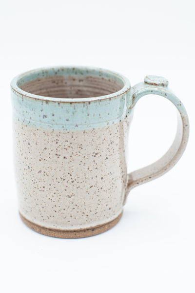 Mug in speckled clay with Spiced Cream and Teal glaze