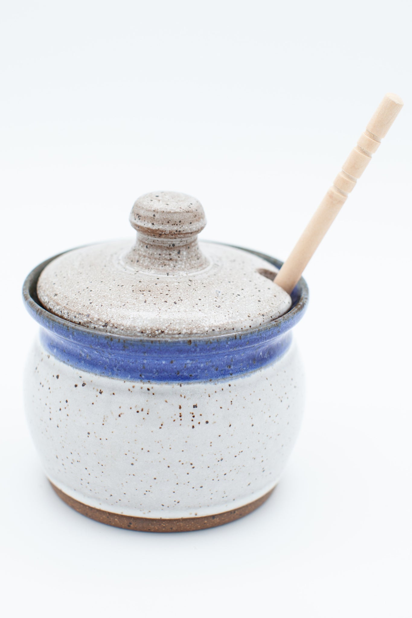 Honey jar in speckled clay with Aspen white and blue glaze