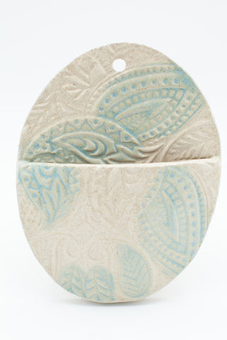 oval wall pocket in teal and spiced cream glaze