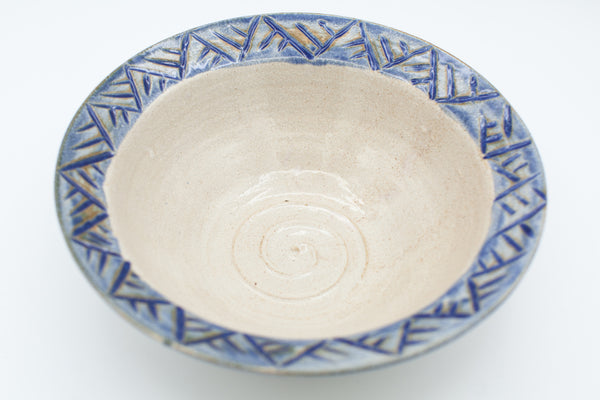 Bowl with carved rim in spiced cream and blue glaze