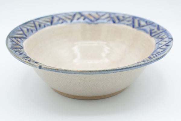 Bowl with carved rim in spiced cream and blue glaze