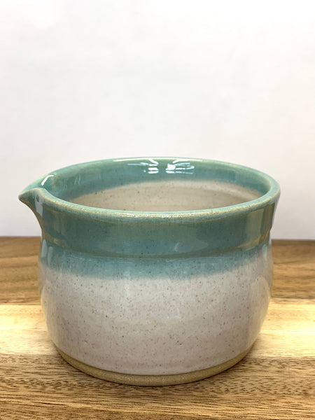 Handmade stoneware matcha bowl in spiced cream and teal glaze