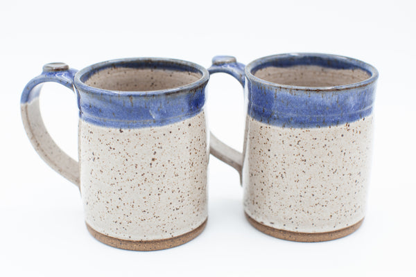 Handmade stoneware mug in speckled clay with spiced cream and blue glaze
