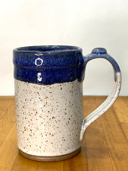 Handmade stoneware mug in speckled clay with spiced cream and blue glaze