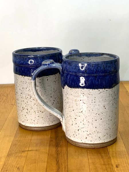 Handmade stoneware mug in speckled clay with spiced cream and blue glaze