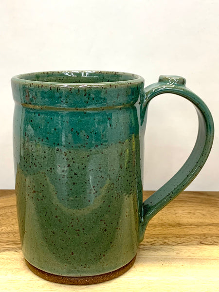 Handmade stoneware mug in speckled clay with teal glaze