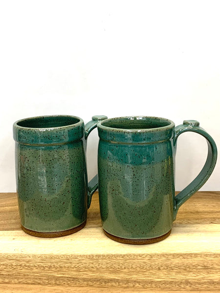 Handmade stoneware mug in speckled clay with teal glaze