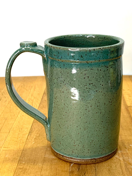 Handmade stoneware mug in speckled clay with teal glaze