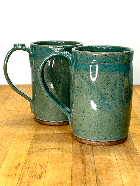 Handmade stoneware mug in speckled clay with teal glaze