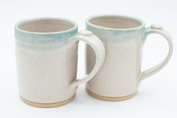 Handmade stoneware mug in buff clay with spiced cream and teal glaze
